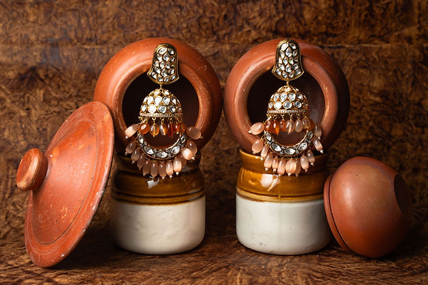 Jadau jhumkaas With a polkie finish With a touch Of semi precious drops,