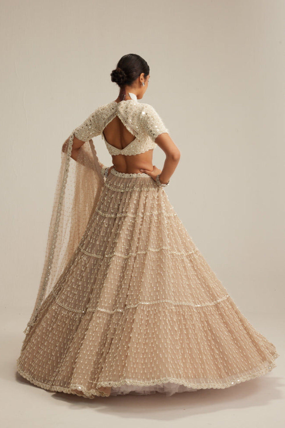 Light Beige Pearl Drop Multi Tier Lehenga With High Neck Blouse Set.