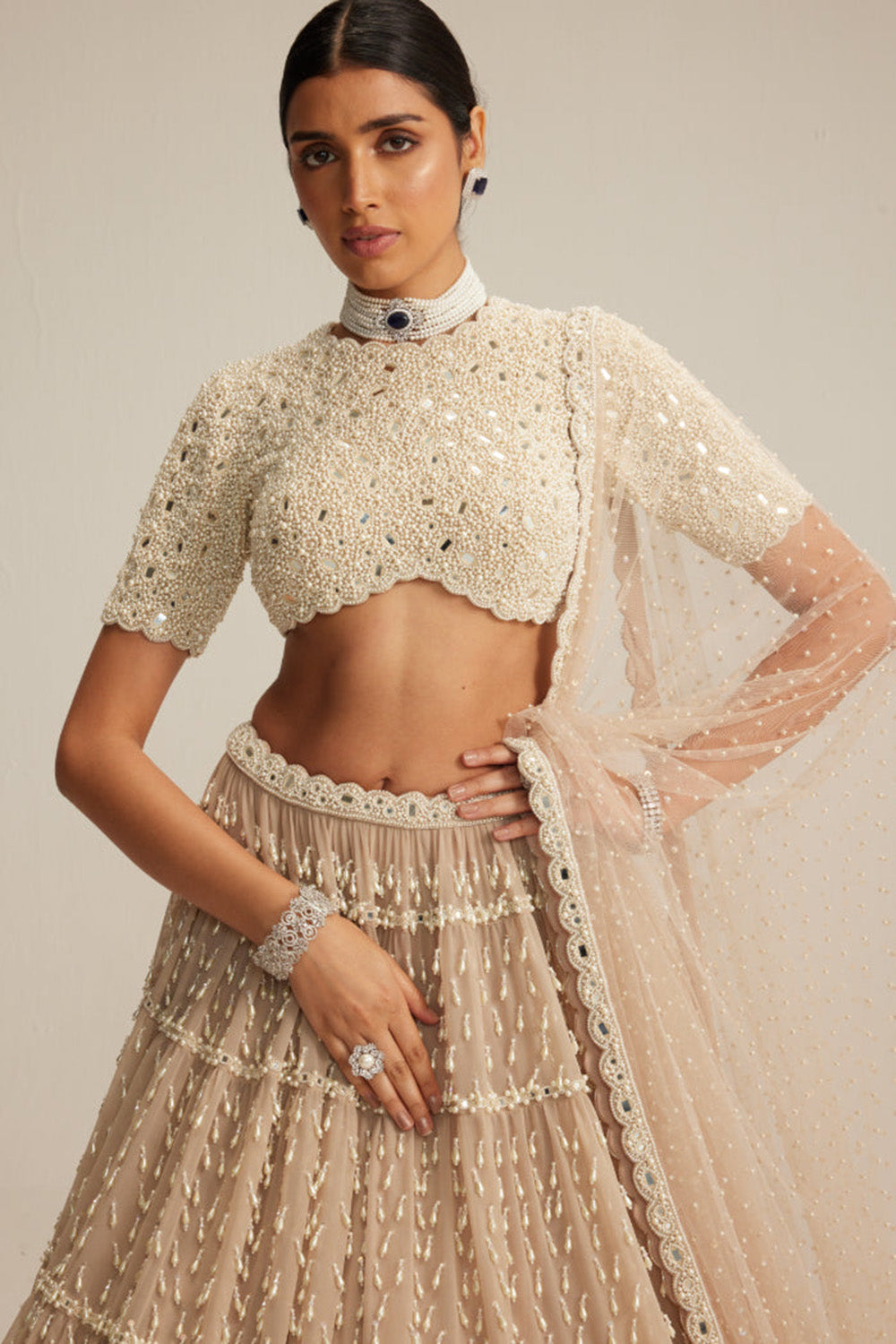 Light Beige Pearl Drop Multi Tier Lehenga With High Neck Blouse Set.