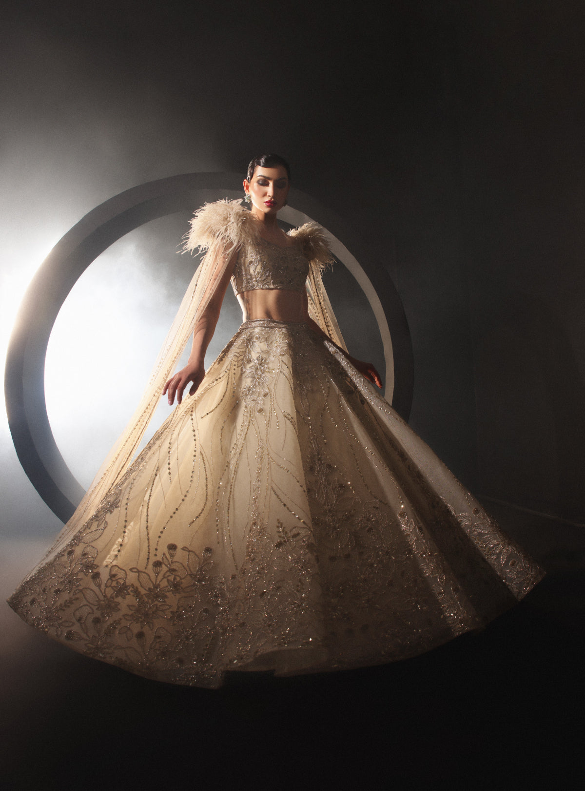 An Embroidered Lehenga With a Floral Motive And Feather Sleeves