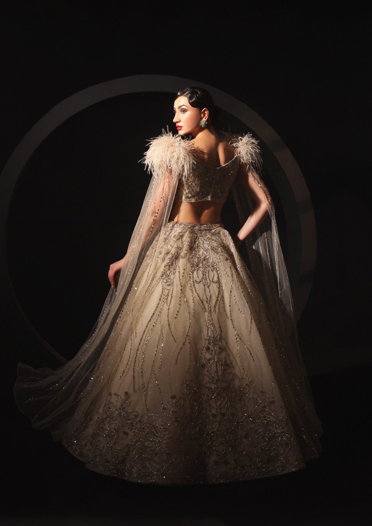 An Embroidered Lehenga With a Floral Motive And Feather Sleeves