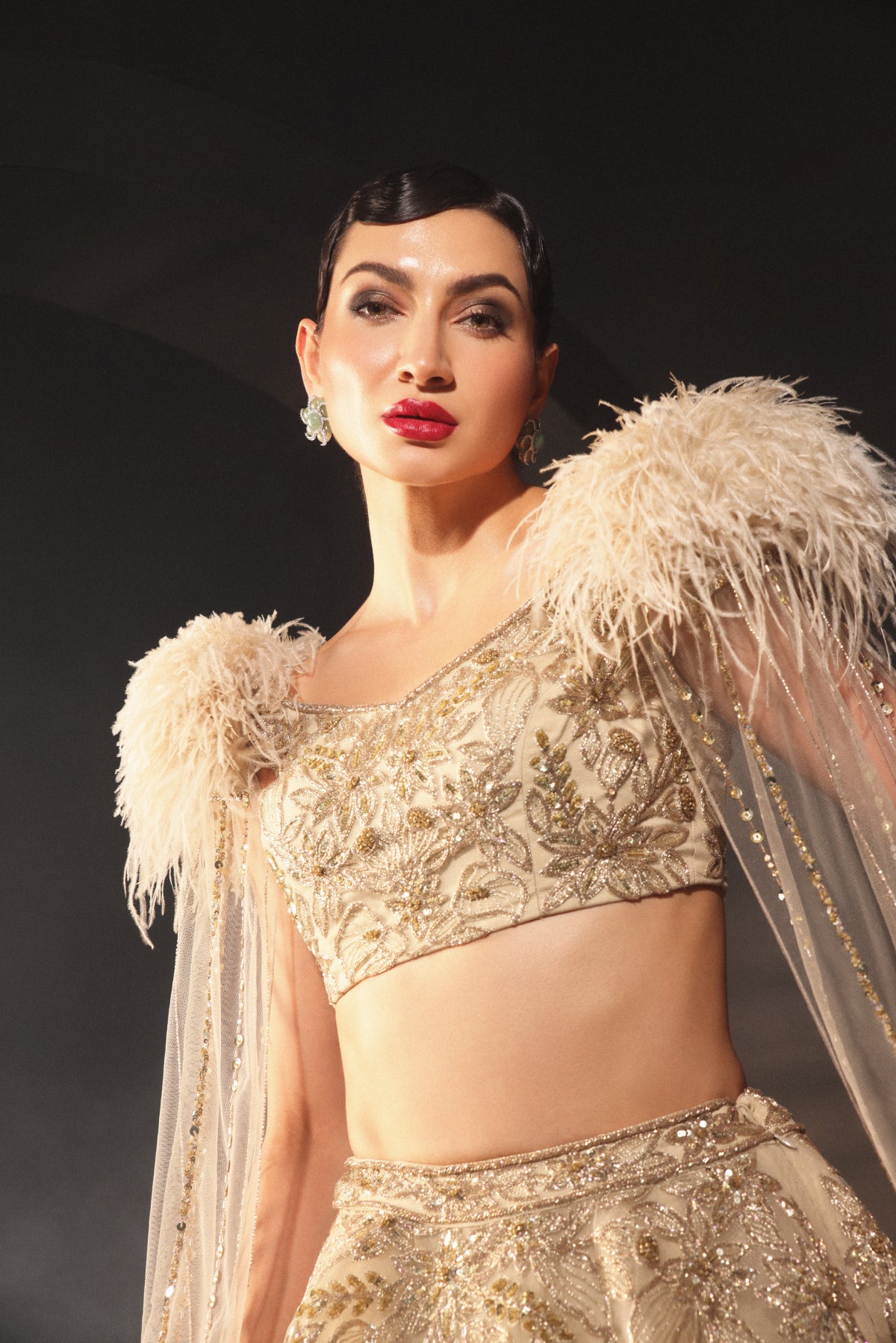 An Embroidered Lehenga With a Floral Motive And Feather Sleeves