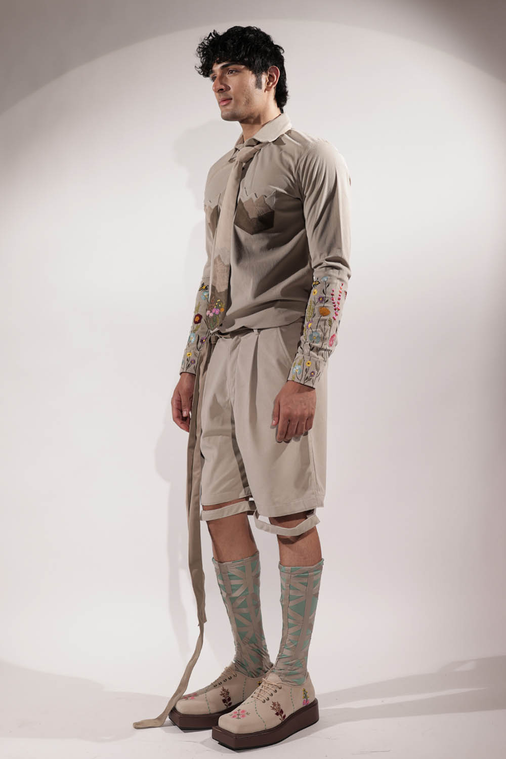 Beige suede shacket with mountain-inspired pockets and floral embroidery