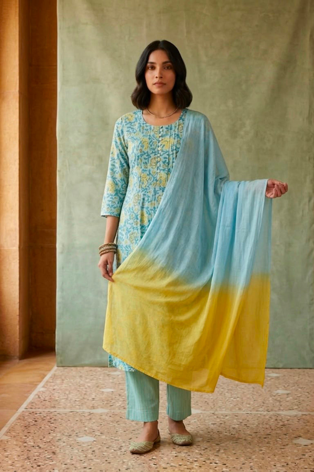 Blue allover block printed kurta paired with strips pants along with shaded duppata