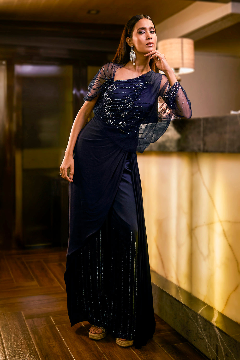 Midnight Blue jumpsuit with sheer sleeve and draped silhouette