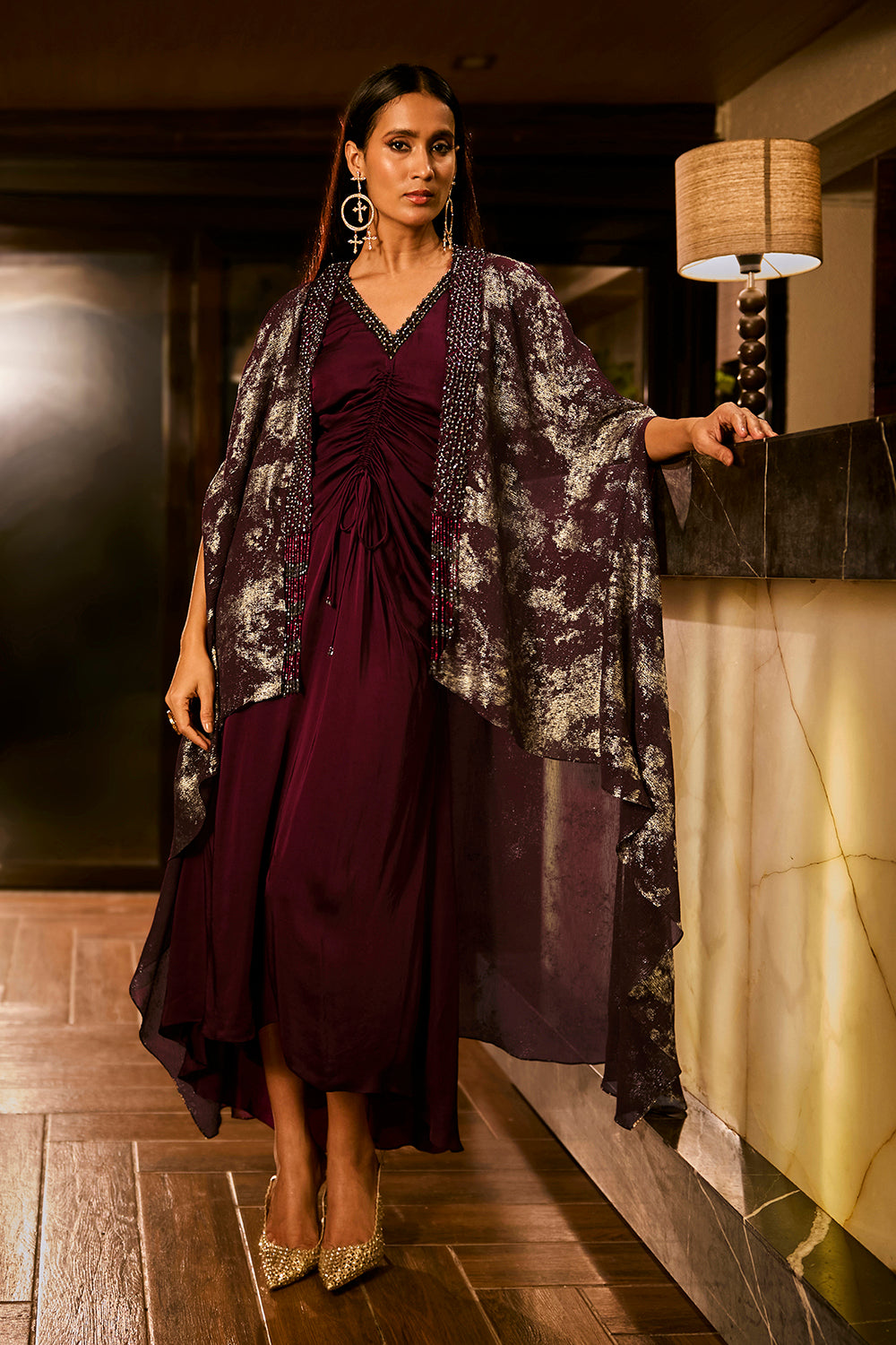 Ruched knot dress with a gold crushed foil cape