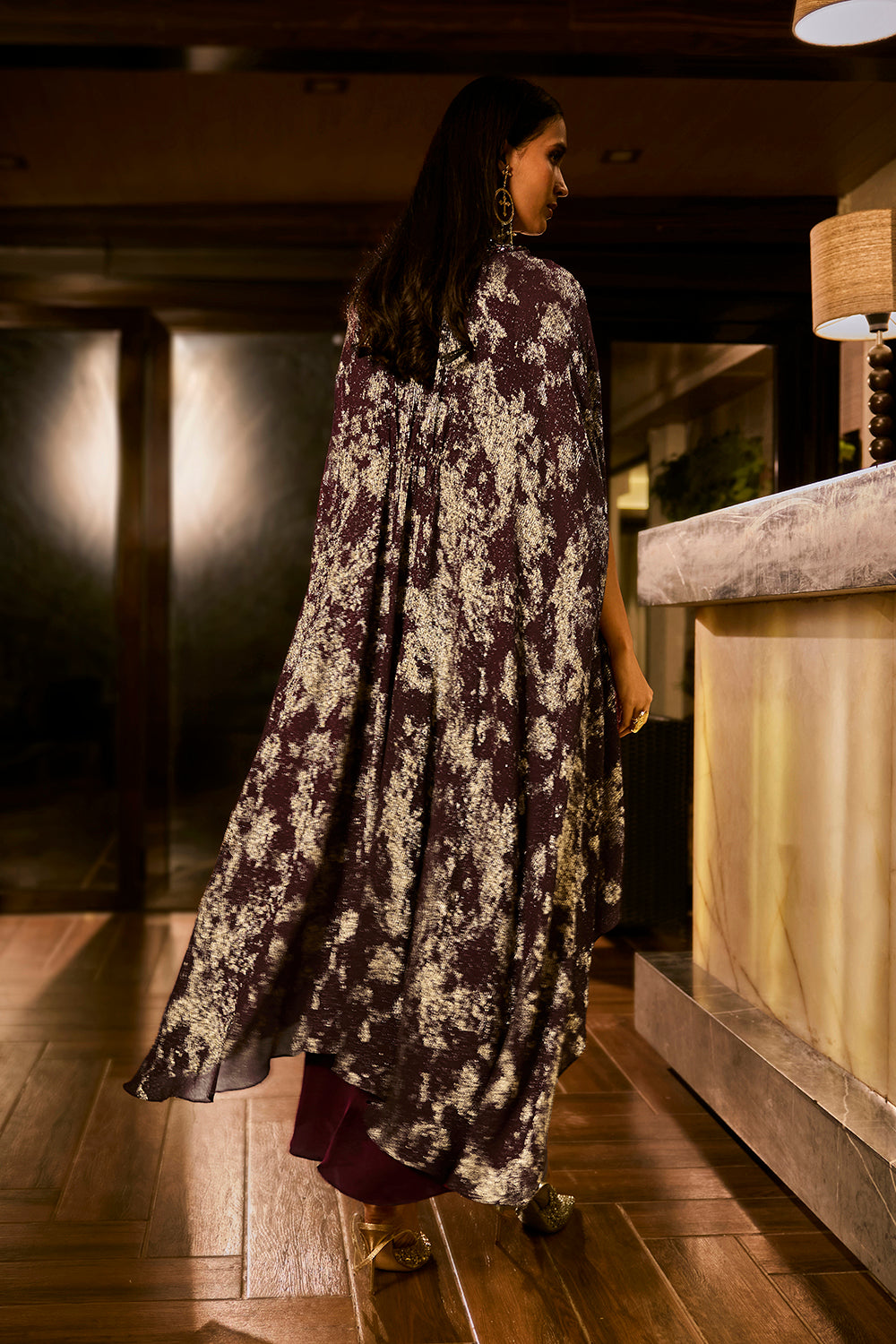 Ruched knot dress with a gold crushed foil cape