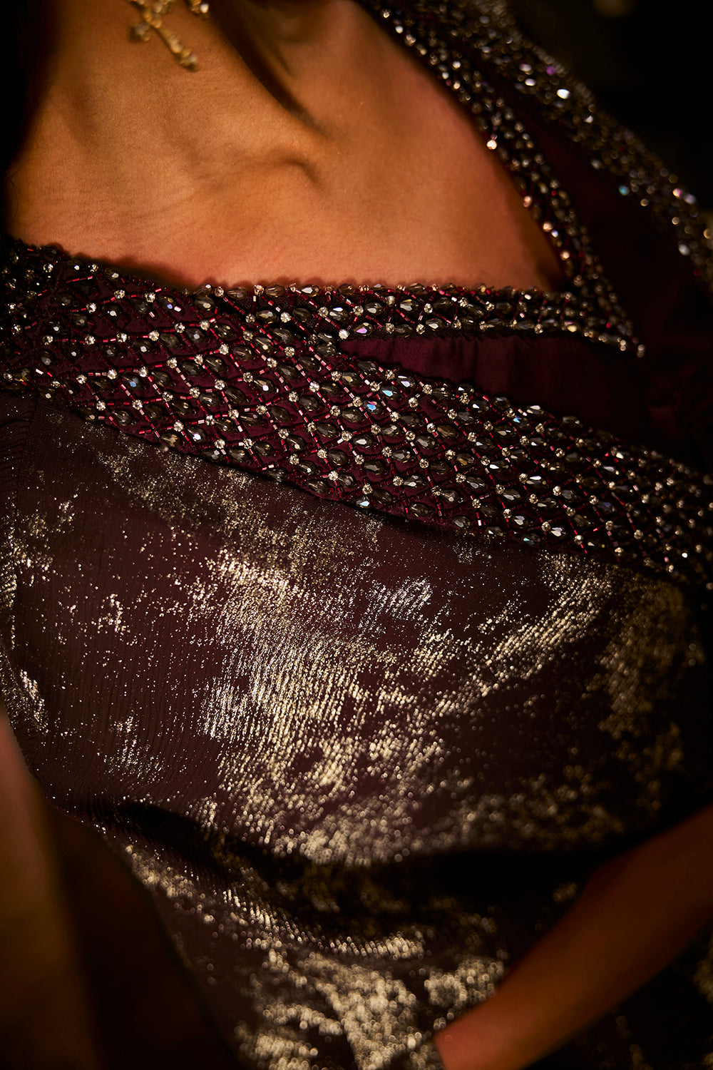 Ruched knot dress with a gold crushed foil cape