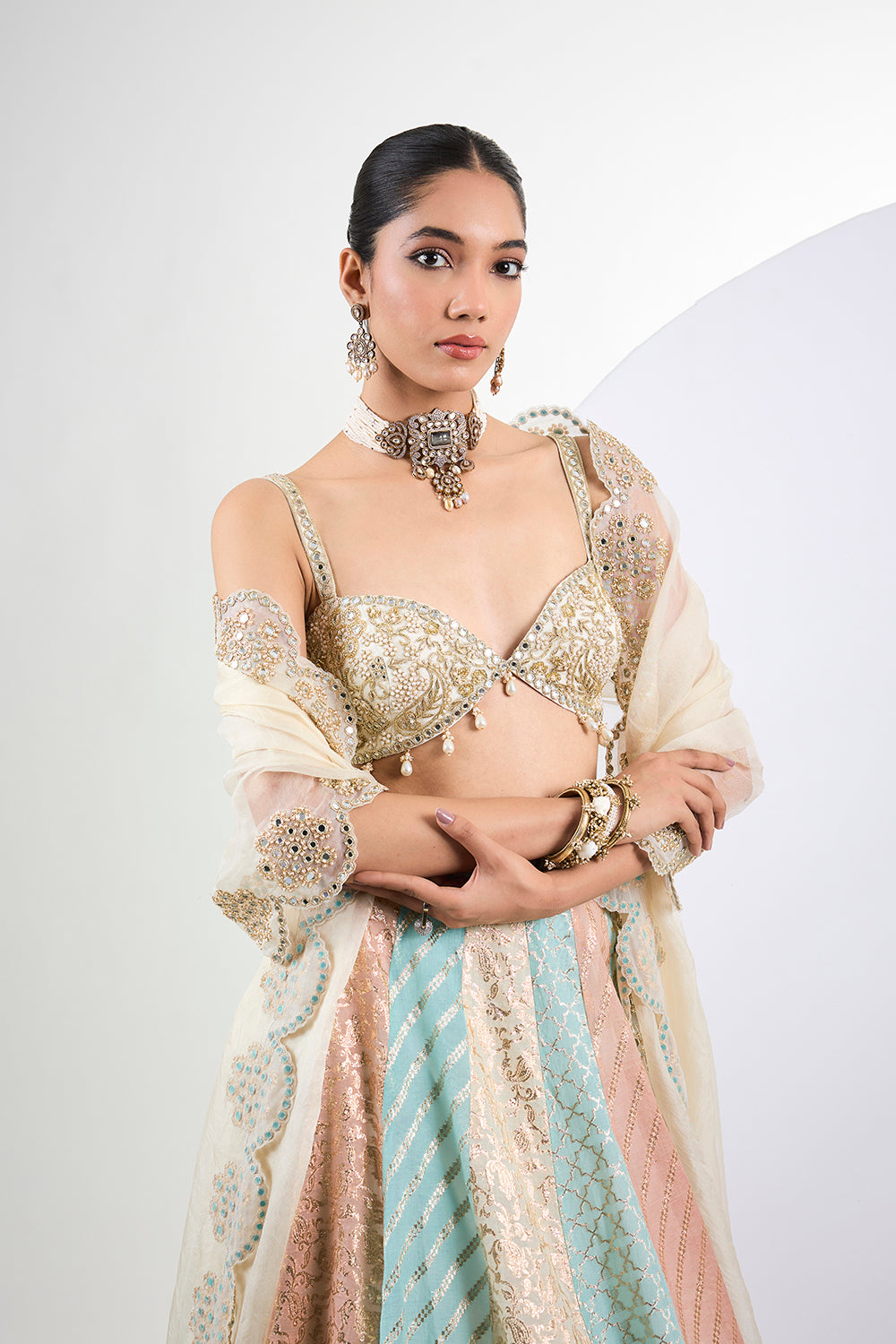 Ivory hand embroidered blouse with Banarasi navrang lehenga and mirror work organza Dupatta