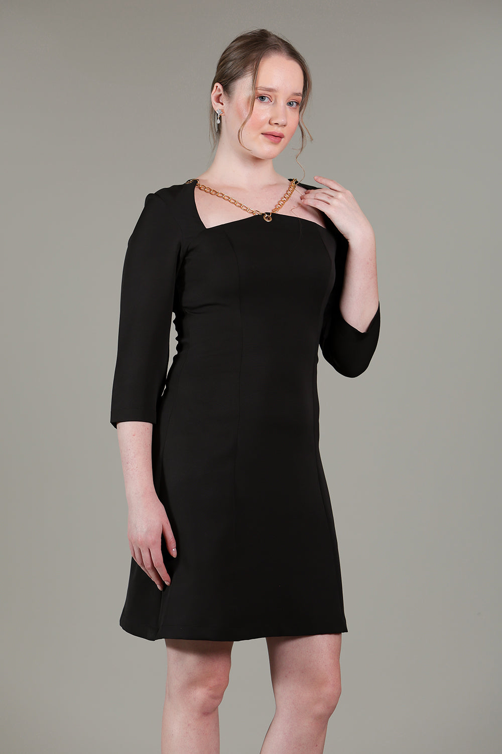 Black dress with gold chain detailing on neck