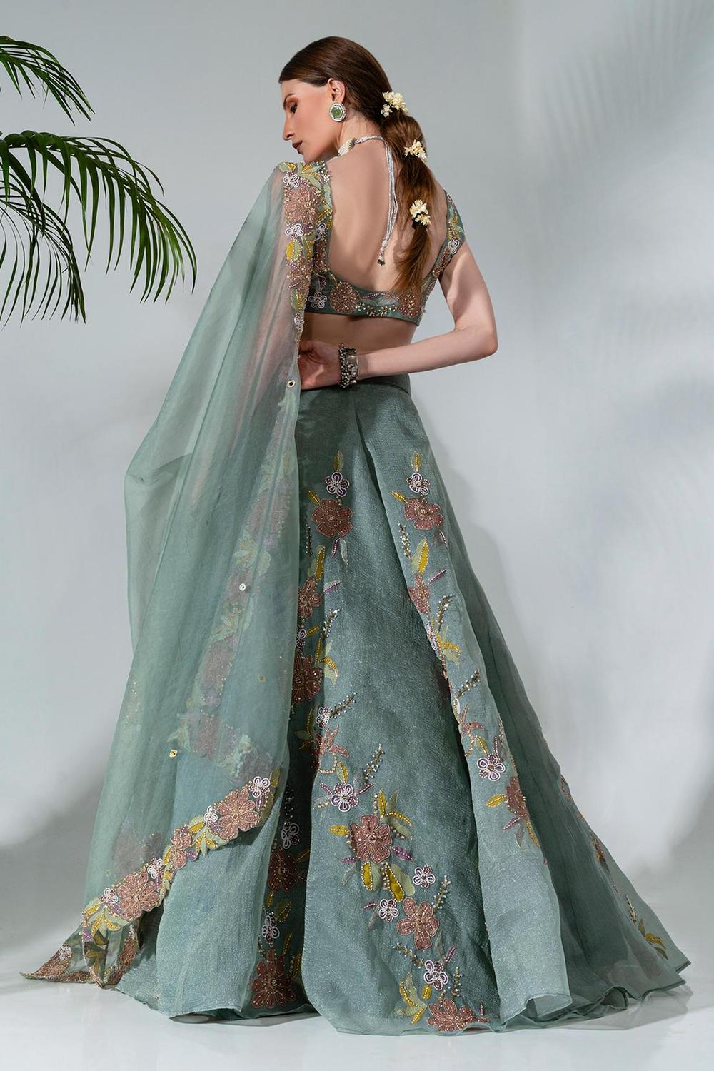 Dusty green lehenga featuring floral applique patterns