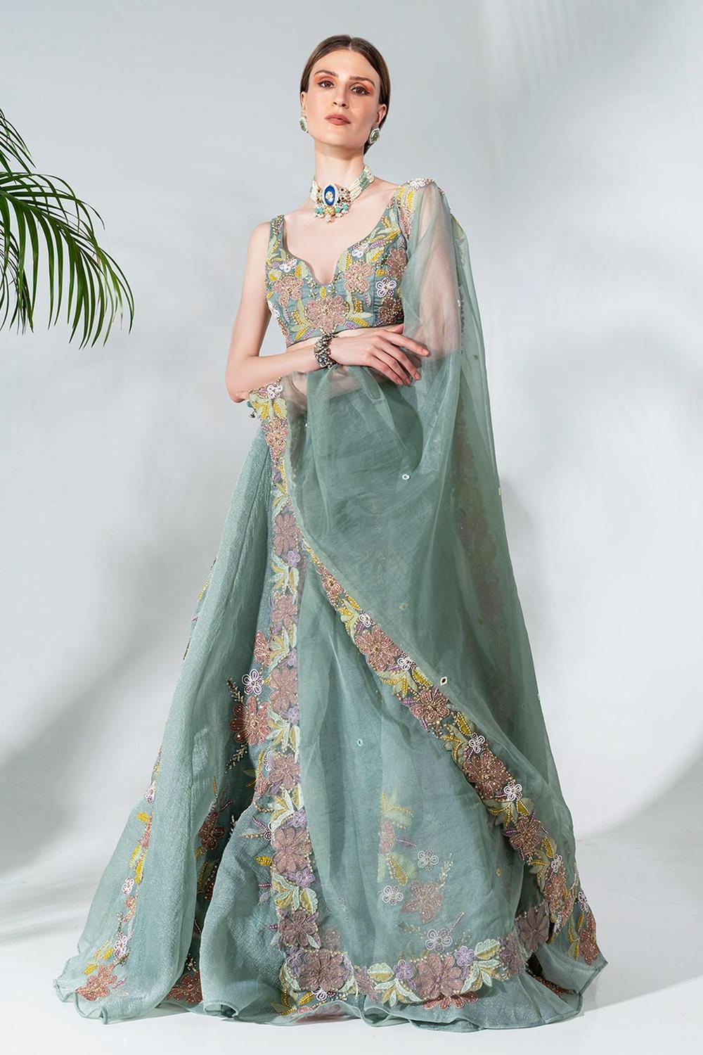 Dusty green lehenga featuring floral applique patterns
