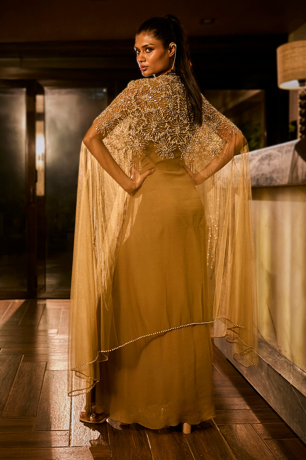 Olive green dress paired with an embellished sheer cape