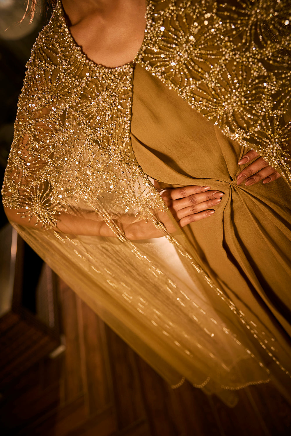 Olive green dress paired with an embellished sheer cape