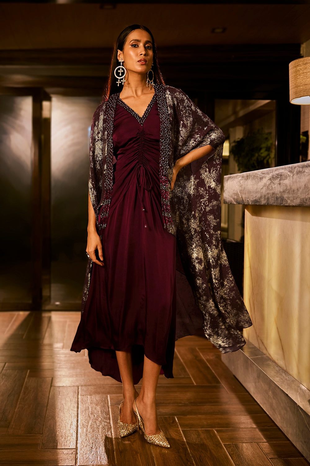 Ruched knot dress with a gold crushed foil cape